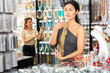 Portrait of focused asian woman visiting bijouterie boutique, looking for elegant necklace