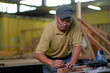 © azami - Carpenter  setting up in installation of roof rafters on a new gazebo construction project