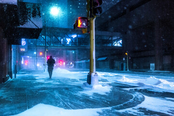 Man walking in the city during winter snow storm.