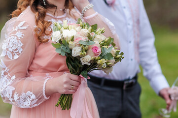 Bouquet of flowers in the hand of the bride