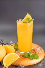 Fresh orange juice in glass with mint, fresh fruits. selective focus.