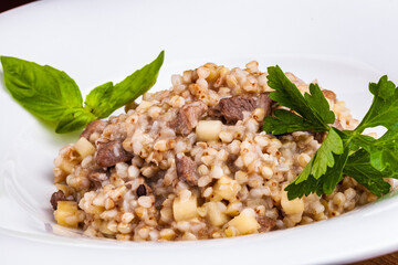 Wall Mural - Buckwheat with duck meat and apple on white plate