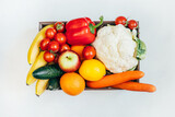 Fototapeta Kuchnia - top view of a box with vegetables and fruits on a white background