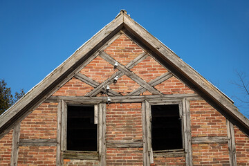 Wall Mural - Old abandoned window, detail of a window of a house in ruins, evictions and abandonment, crisis, wooden and brick house before total destruction	