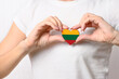 Love Lithuania. The girl holds a heart in the form of the flag of Lithuania on her chest. Lithuanian concept of patriotism