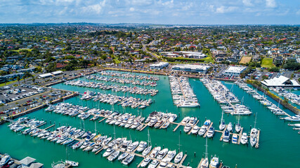 Wall Mural - Aerial view on a marina with a residential suburb in the background. Auckland, New Zealand.