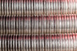 many round metal coins of silver color illuminated in red