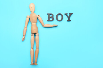 Wall Mural - Wooden mannequin with word BOY on color background