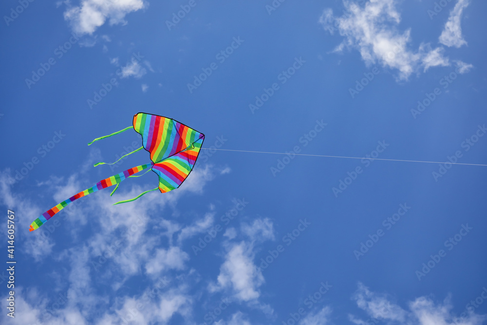 Colorful kite flying in blue sky
