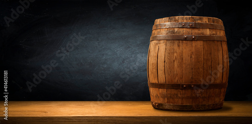 Obraz Dibond Old wooden barrel on a brown background