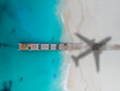 Drone photo of pier in Grace Bay, Providenciales, Turks and Caicos, airplane shadow