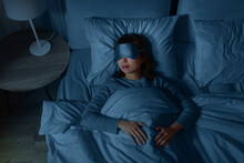 People, Relax And Comfort Concept - Young Asian Woman In Eye Mask Sleeping In Bed At Home At Night