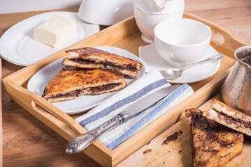 Wall Mural - French breakfast on a wooden tray - French toast, coffee and cream