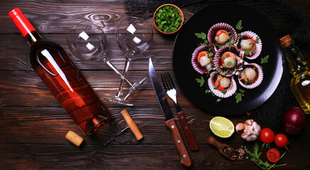 Canvas Print - Fresh scallops with a bottle of rose wine with spices and vegetables