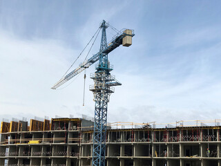 Construction site with cranes on sky background