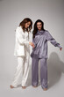 © indiraswork - Two friends sexy brunette woman luxury lifestyle bright makeup wear natural organic silk suit pants blouse  high heels perfect body shape fashion model style for meeting party or romantic date studio.