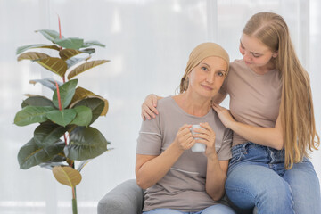 Wall Mural - A young and beautiful grateful daughter taking care and encourage her mother's cancer patient and fortifies her to fight during the chemotherapy