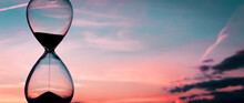 Time Passing At Sunset With Hourglass