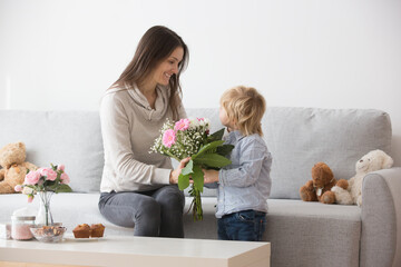 Sticker - Beautiful blond boy, giving mother flowers and box with little gift for mothers day