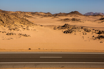 Road in the sahara desert of Egypt. Conceptual for freedom, enjoying the journey. Empty road. Freeway, Highway through the desert