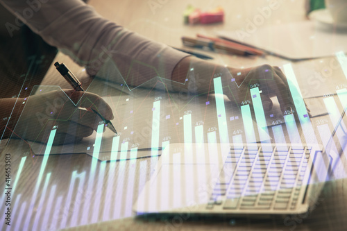 Obraz Dibond Double exposure of businesswoman hands typing on computer and forex chart hologram drawing. Financial analysis concept.