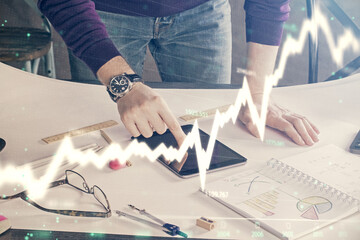 Aufkleber - Double exposure of man's hands holding and using a digital device and forex graph drawing. Financial market concept.