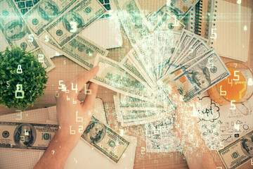 Multi exposure of technology drawing hologram and us dollars bills and man hands. Data concept