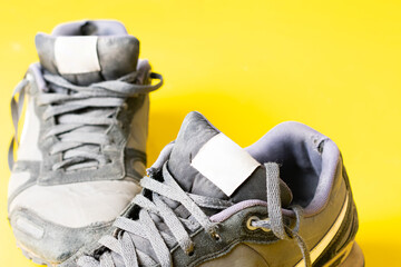 Sports shoes in yellow background