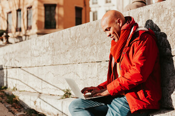 Wall Mural - young latin man with smartphone in the city of lyon