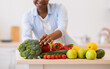 © Prostock-studio - Unrecognizable Black Woman Cooking Vegetables Standing In Modern Kitchen, Cropped