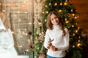 Wall Mural - beautiful teenage girl at home near christmas tree 