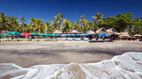 Fototapeta Góry - White sand beach Bali with sand and palm trees and waves