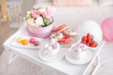 Fototapeta Kuchnia - Flowers and sweets on white table and balloons on the white bed. Gift for Valentine's day or March 8 or Mother's Day or birthday
