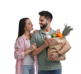 Poster - Young couple with groceries on white background