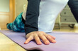 © Manuel - Stock photo of unrecognized woman wearing sports clothes doing body work out in her living room. Selective focus.
