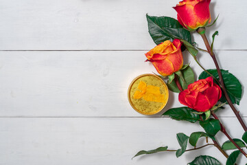 Wall Mural - A bouquet of red roses and a gift box on the table in the interior. Love confession. Valentine's day celebration