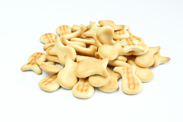 Pile of salty crackers isolated on white background. Fish shaped snack