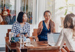 © Fxquadro - Female team of asian women sit at table together and planning their prohect using a laptop in comfortable office in daytime.