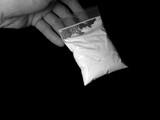 Fototapeta Krajobraz - Men holding cocaine drug powder bag during illegal deal