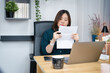 © tickcharoen04 - asian woman check her tax and use laptop for refund from home