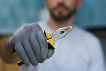 Necessary Hand Tool. Close Up Shot Of Hand Of Young Repairman Holding Pliers