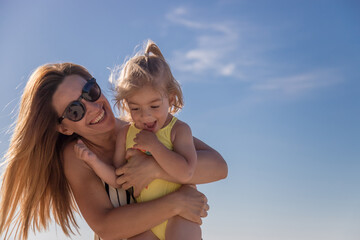 Happy mother and daughter having fun on the beach.Happy family.Positive human emotions, feelings.