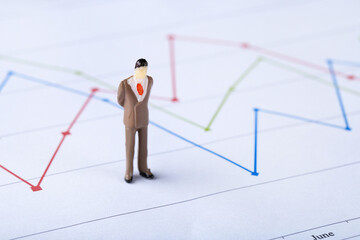 Poster - Miniature people and financial papers with graph and charts