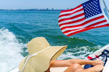 Young woman wearing a hat on a boat cruising the bay in Miami, Florida