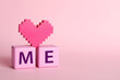 © New Africa - Phrase Love Me made with cubes and heart on pink background