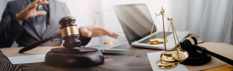 justice and law concept.Male judge in a courtroom on wooden table and Counselor or Male lawyer working in office. Legal law, advice and justice concept.