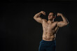 © Ilya - Man's biceps shows bare torso Young male confident fashion, casual bodybuilder. Beautiful trendy, dumbbell smile background black bodybuilder