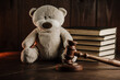 Divorce and alimony concept. Wooden gavel and teddy bear as symbol of child on a desk.