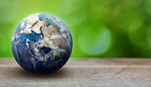 Earth Planet Sphere On Green Leaves Background. Ecology And Environment Care Concept. Greenpeace And Earth Day Theme. Elements Of This Image Furnished By NASA