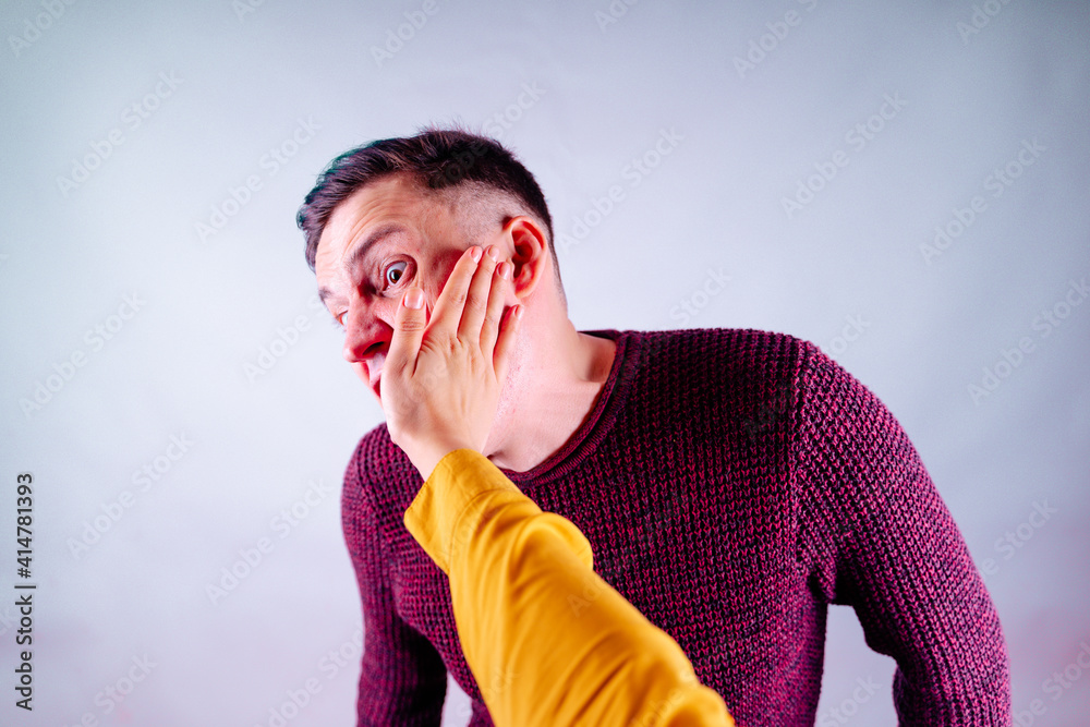 Crop person slapping scared man in face. Emotional male getting slapped ...
